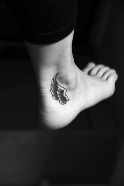 black wings tattoo on foot