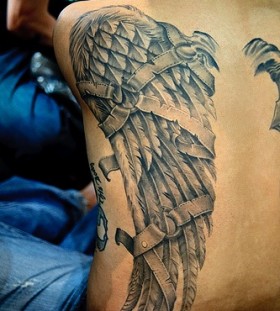 Amazing broken wing tattoo