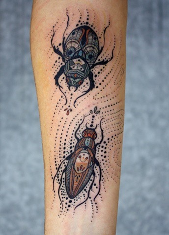 Black bug tattoo