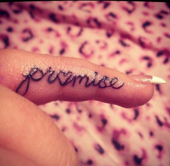 Black finger promise tattoo