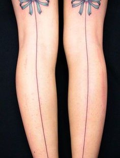 Bows on leg tattoo