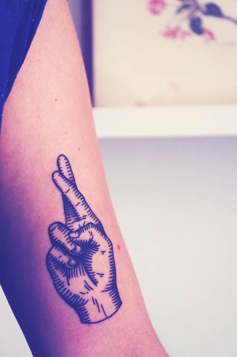 Crossed fingers minimalistic style tattoo