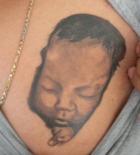 Cute tattoo with sleeping baby