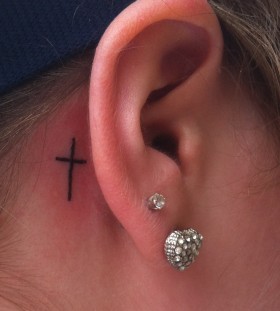 Ear cross tattoo