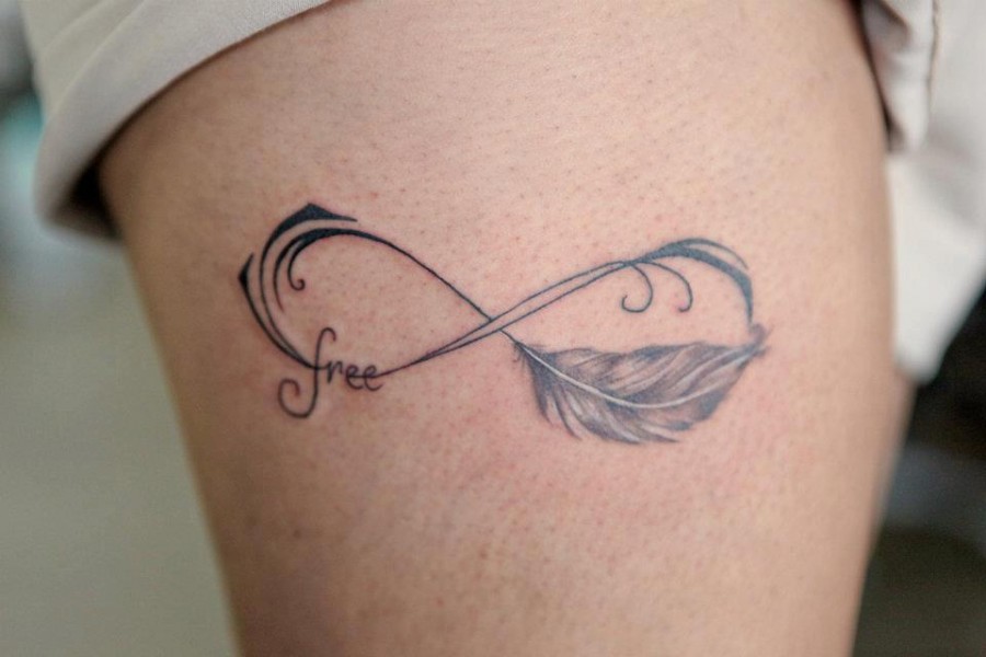Feather tattoo by Nikki Ouimette