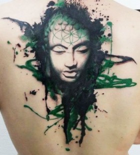 Green face tattoo on the back