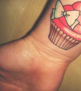 Impressive tattoo with cake and bow