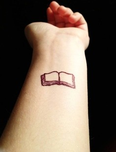 Little book tattoo on hand