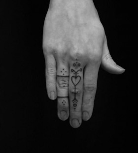 Lovely finger tattoo by Jean Philippe Burton