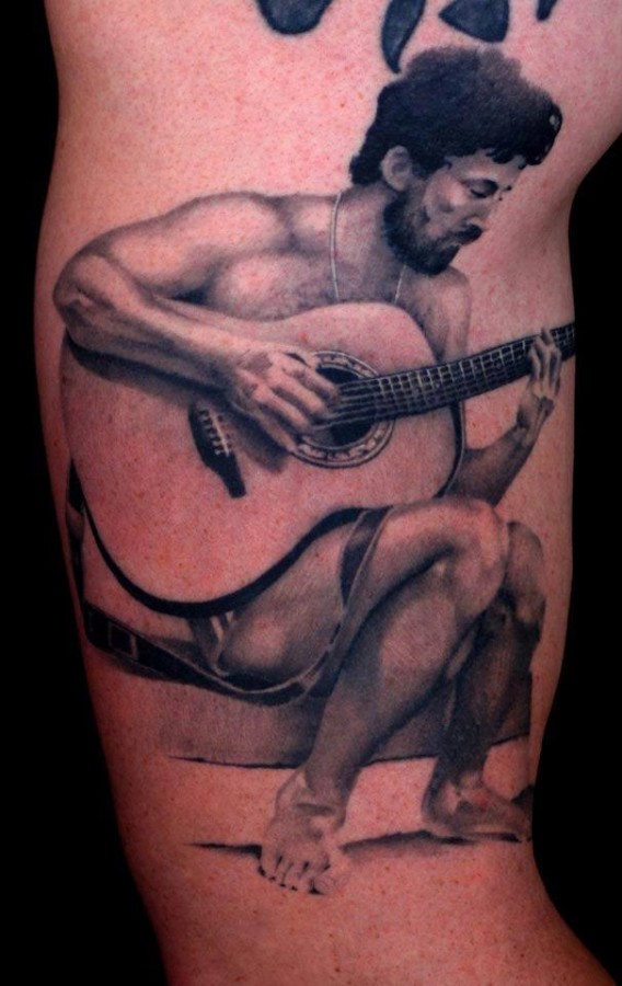 Man and guitar tattoo by Art Junkies