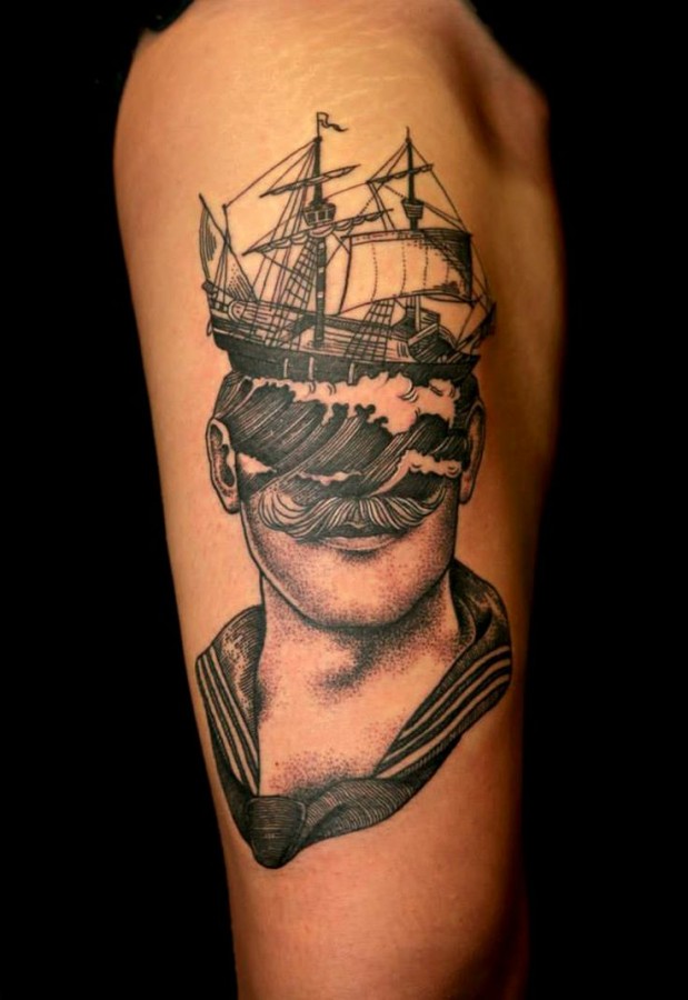 Ship and man head tattoo