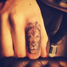 Small lion tattoo on finger
