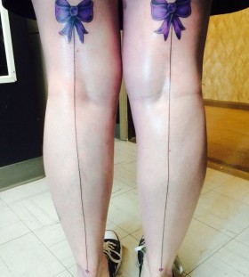 Two purple bows tattoo