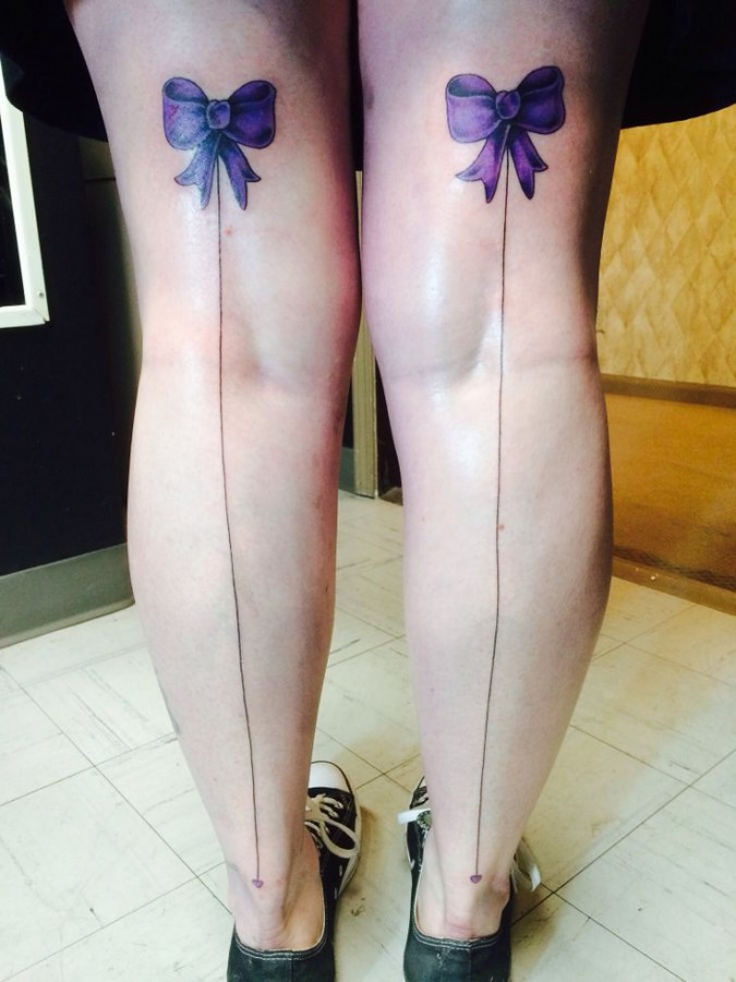 Two purple bows tattoo