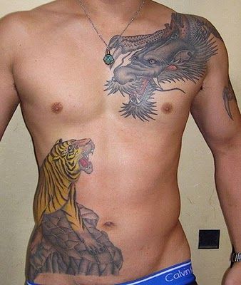 Angry lion and dragon tattoo