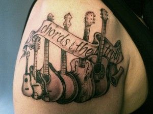Awesome black guitar tattoo