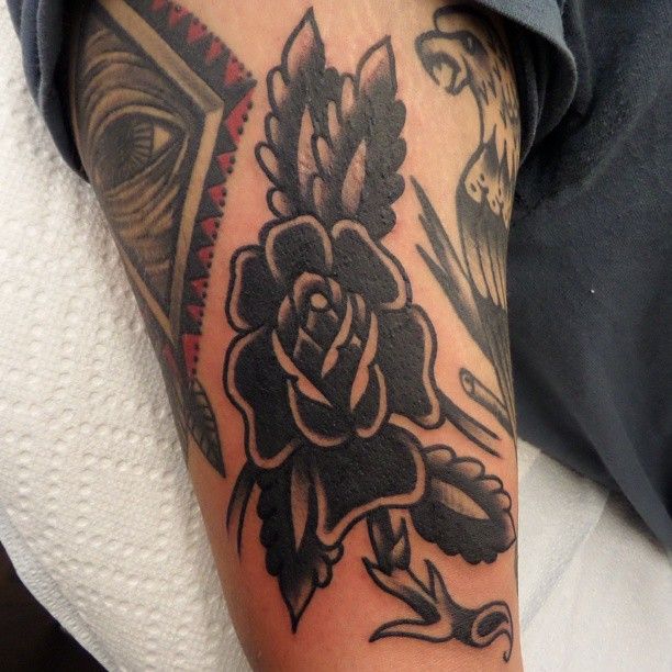Black flowers tattoo by Dustin Barnhart