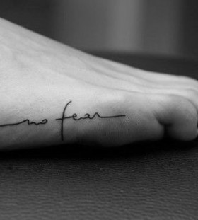 Black letters foot tattoo