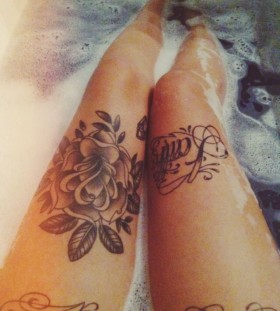 Black rose and words legs tattoo