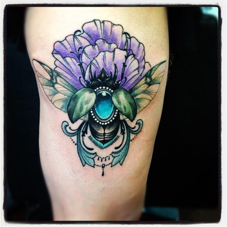 Blue and purple insect tattoo