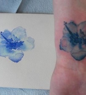 Blue flower painting tattoo