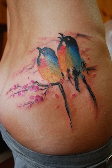 Colorful bird watercolor tattoo