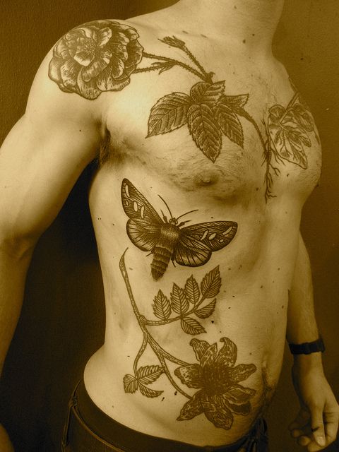 Insects and flowers tattoo made by Berlin artist