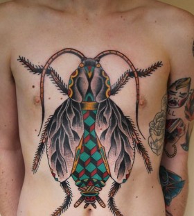 Men's chest insect tattoo