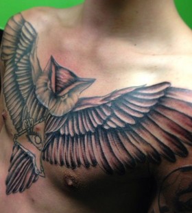 Men's chest owl tattoo