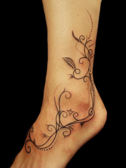 Ornaments and feather foot tattoo