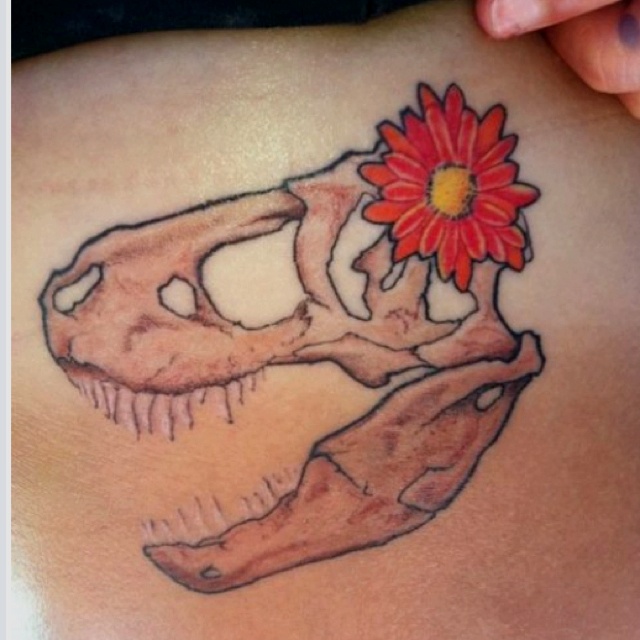 Red flower and dinosaur tattoo