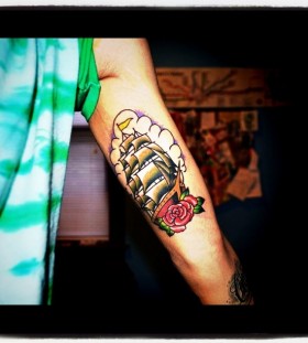 Red rose and green ship tattoo