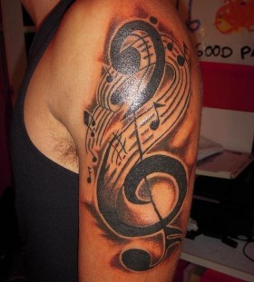Shoulder music style tattoo