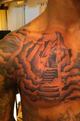 Sky and clouds tattoo on chest