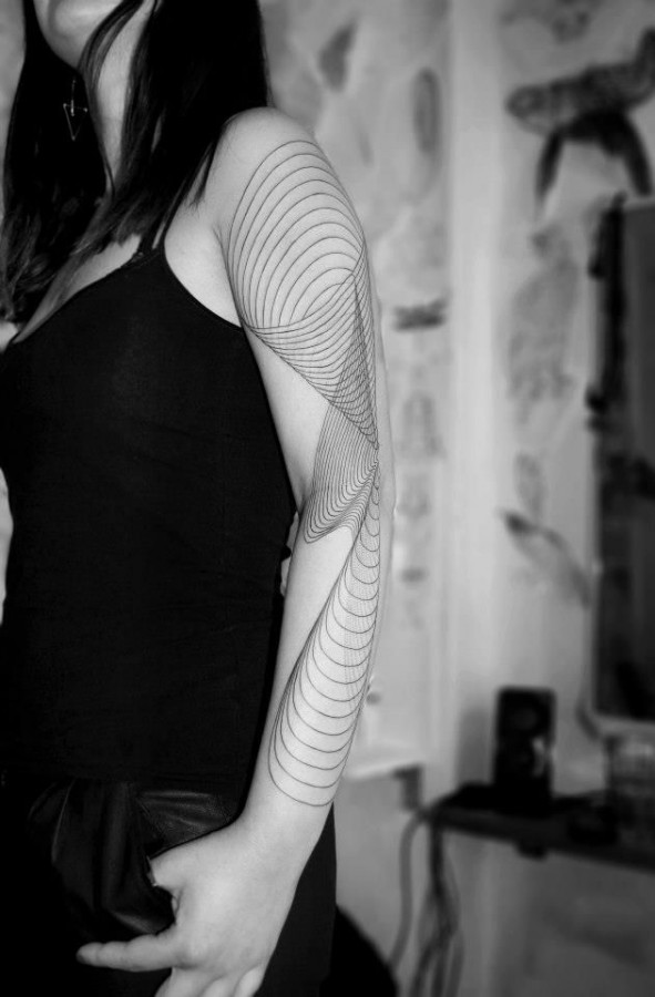 Woman arm tattoo by Chaim Machlev