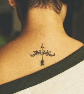 Woman's back arrow tattoo