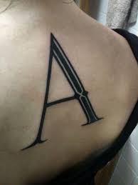 A letter tattoo on back