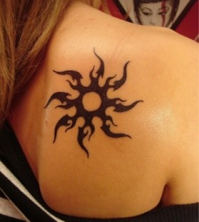 Adorable black back sun tattoo