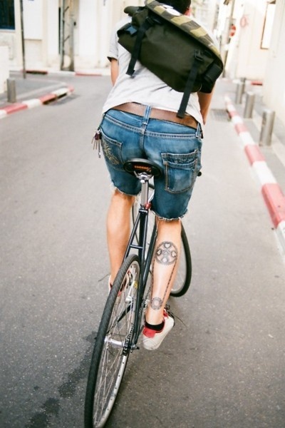 Adorable black bicycle tattoo on leg