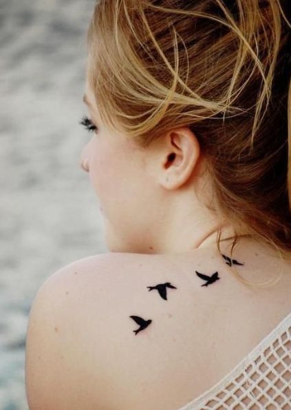 Adorable black bird tattoo on shoulder