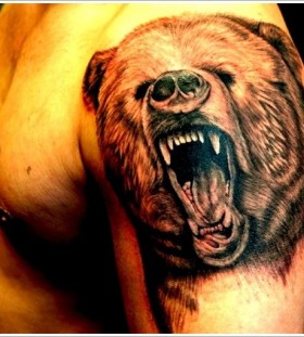 Adorable brown bear tattoo on arm