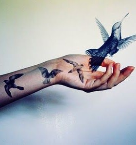 Adorable realistic bird tattoo on arm