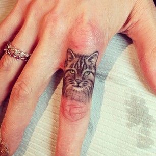 Adorable realistic cat tattoo on finger