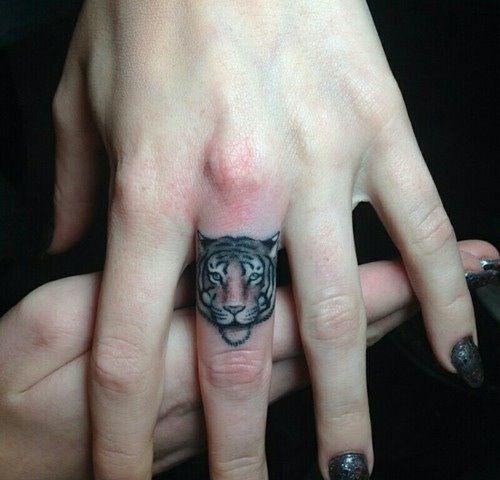 Adorable tiger cat tattoo on finger
