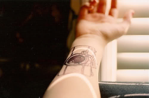 Amazing black camera tattoo on arm