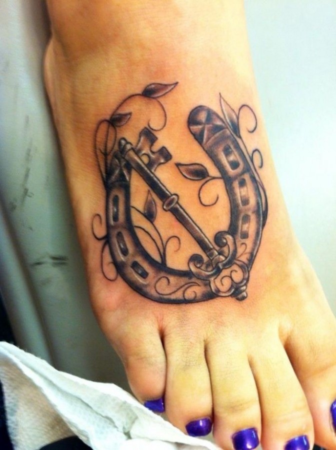 Amazing black horse shoe tattoo