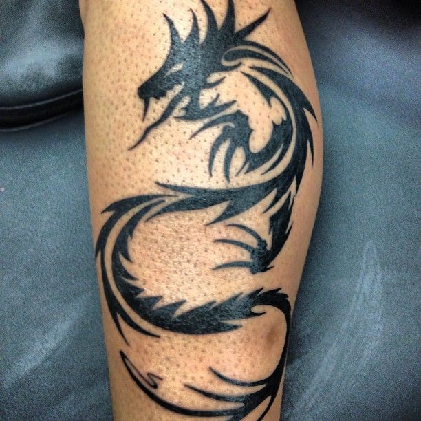 Amazing dragon tribal tattoo on leg