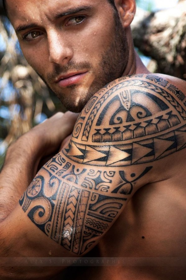Amazing eyes men’s tribal tattoo on arm