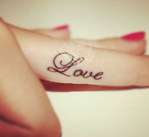 Amazing red nails and love tattoo on arm