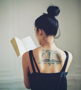 Amazing women's back book tattoo